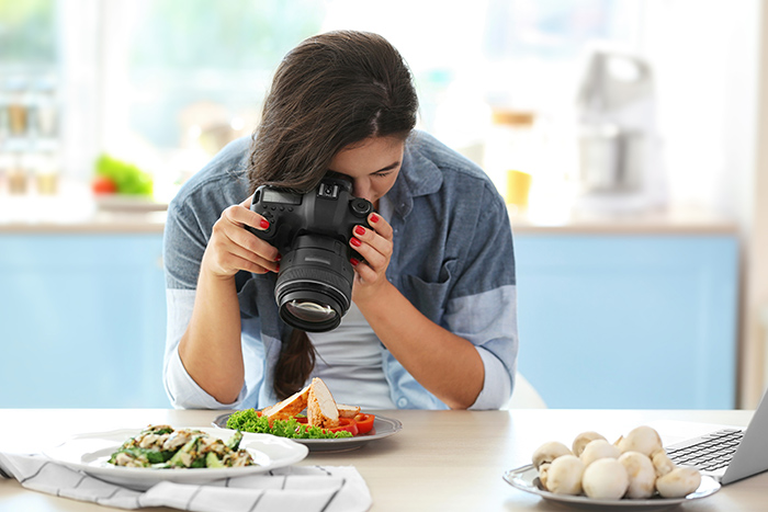 A Woman Making a Video of Food for Her Vlog