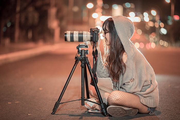 female photographer taking pictures at night